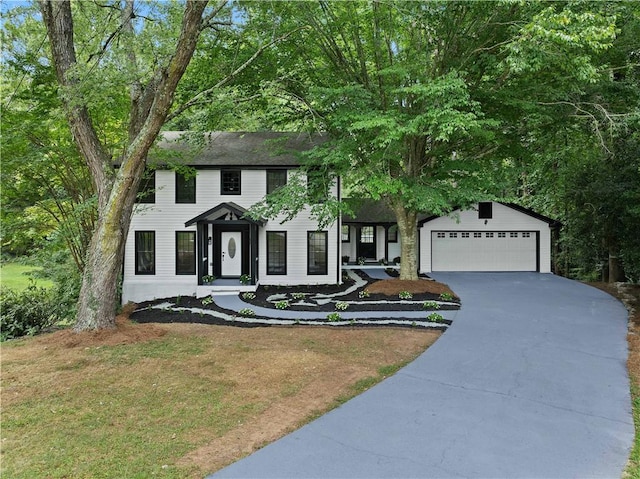 colonial house with a garage and a front yard