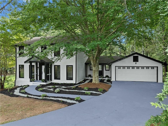 colonial house featuring a garage and driveway