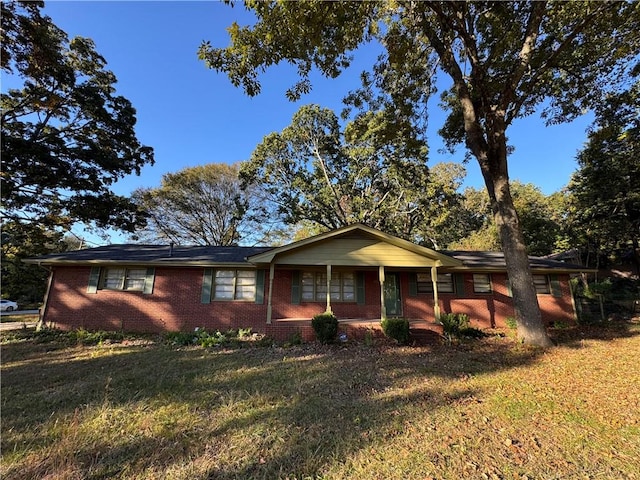 ranch-style home with a front lawn