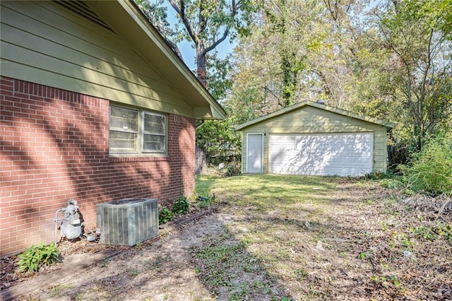 view of side of home featuring an outbuilding, a garage, and central AC unit