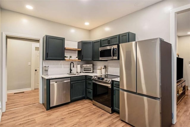 1336 Mcclelland Ave, Atlanta, GA 30344 - kitchen with stainless steel appliances, light countertops, backsplash, light wood-style floors, and open shelves