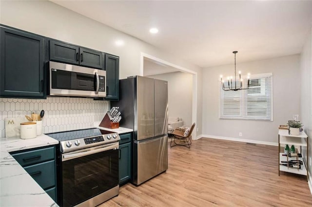 1336 Mcclelland Ave, Atlanta, GA 30344 - kitchen featuring stainless steel appliances, a chandelier, backsplash, light wood-type flooring, and light stone counters