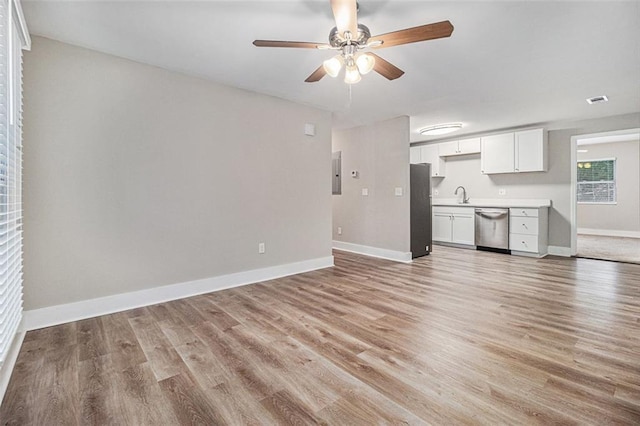 unfurnished living room with sink, ceiling fan, and light hardwood / wood-style floors