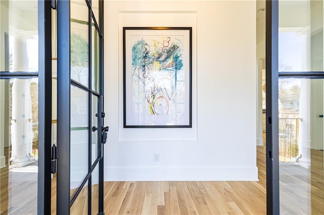 entryway with light wood-type flooring and baseboards