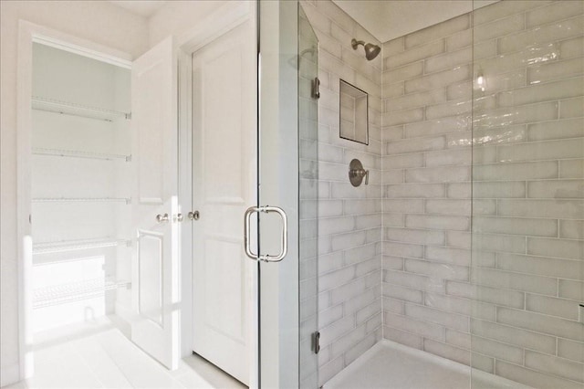 bathroom with a shower with door