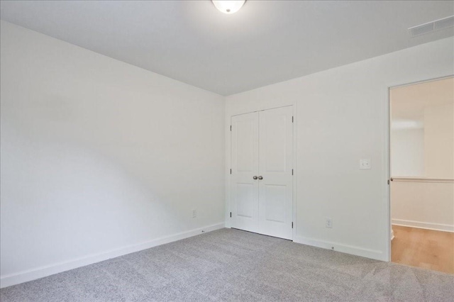 unfurnished bedroom with carpet and a closet