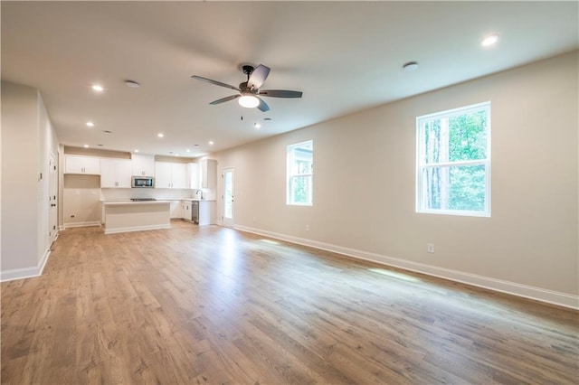 138 Henley St, Canton, GA 30114 - unfurnished living room with ceiling fan, baseboards, recessed lighting, and light wood-type flooring
