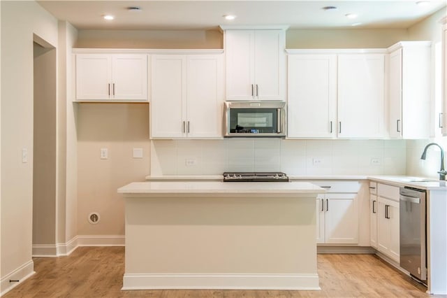 138 Henley St, Canton, GA 30114 - kitchen featuring appliances with stainless steel finishes, a kitchen island, white cabinets, backsplash, and recessed lighting