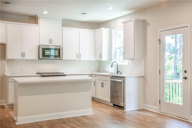 138 Henley St, Canton, GA 30114 - kitchen featuring appliances with stainless steel finishes, light wood finished floors, tasteful backsplash, healthy amount of natural light, and recessed lighting