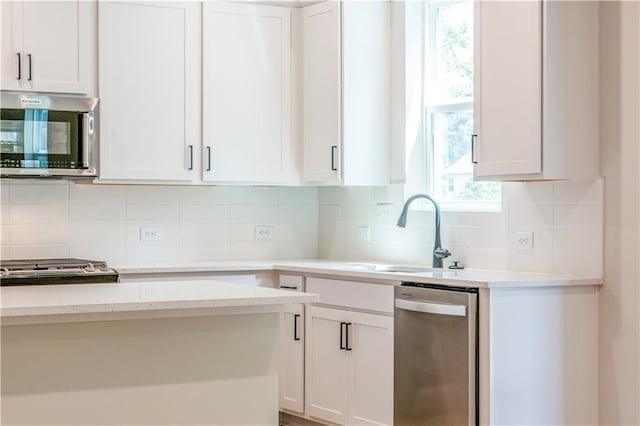 138 Henley St, Canton, GA 30114 - kitchen with stainless steel appliances, a sink, white cabinets, tasteful backsplash, and light stone counters