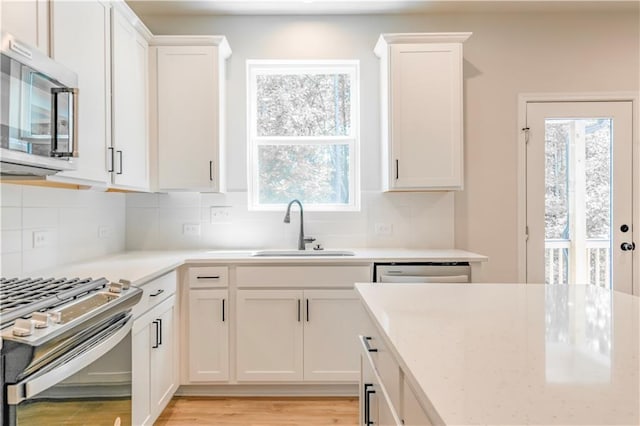 138 Henley St, Canton, GA 30114 - kitchen with appliances with stainless steel finishes, a sink, healthy amount of natural light, and backsplash