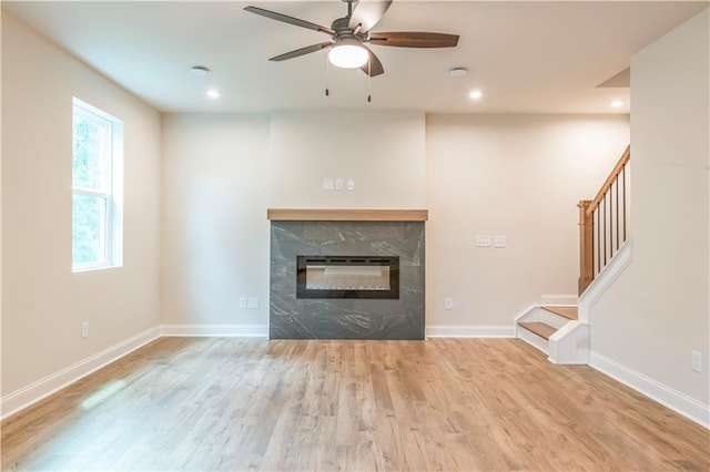 138 Henley St, Canton, GA 30114 - unfurnished living room featuring wood finished floors, a ceiling fan, recessed lighting, stairs, and a fireplace