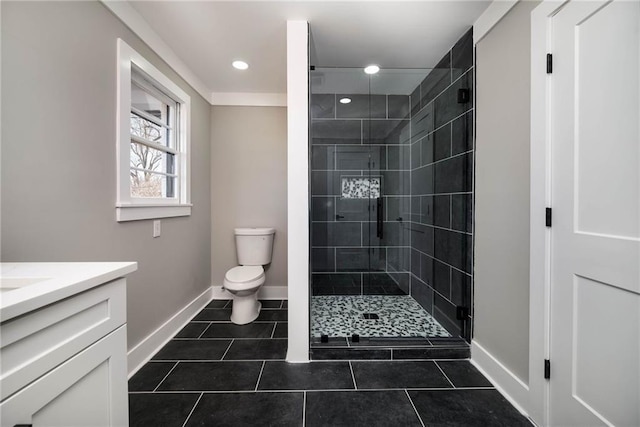 full bathroom with vanity, baseboards, a shower stall, and toilet