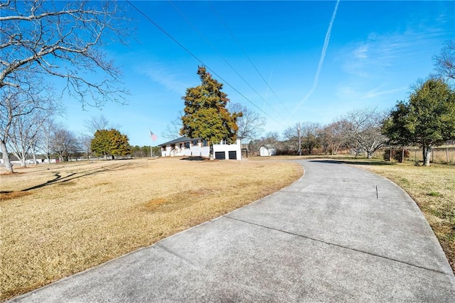 view of road with concrete driveway
