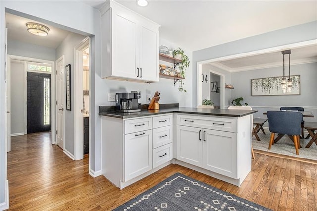 1175 Haven Brook Way, Atlanta, GA 30319 - kitchen with dark countertops, light wood finished floors, white cabinets, a peninsula, and open shelves