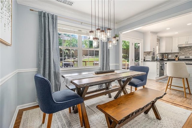 1175 Haven Brook Way, Atlanta, GA 30319 - dining space with healthy amount of natural light, light wood-style floors, crown molding, and a chandelier