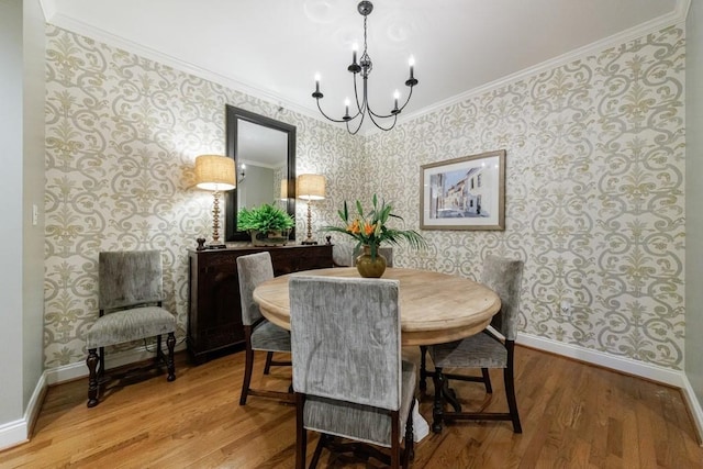 50 Biscayne Dr NW Unit 4110, Atlanta, GA 30309 - dining space with wallpapered walls, a chandelier, baseboards, crown molding, and wood finished floors