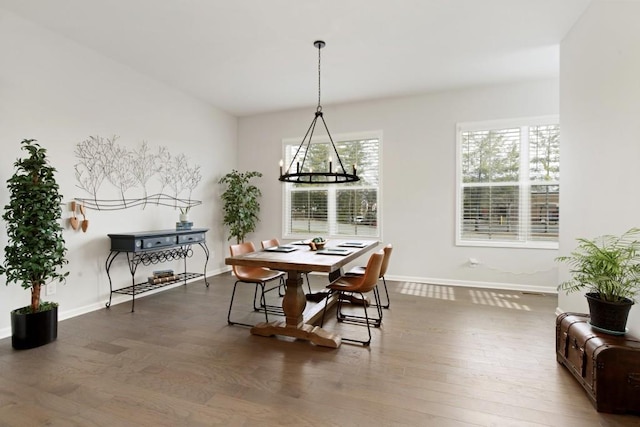 dining space featuring an inviting chandelier and wood-type flooring