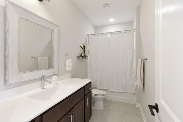 full bathroom with shower / bath combo, tile patterned floors, vanity, and toilet