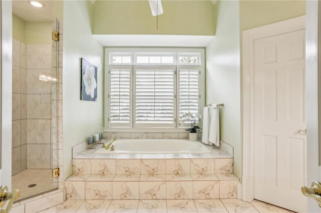 bathroom with a bath, marble finish floor, a shower stall, and plenty of natural light