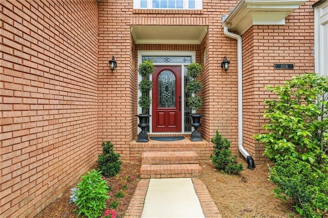 view of exterior entry with brick siding