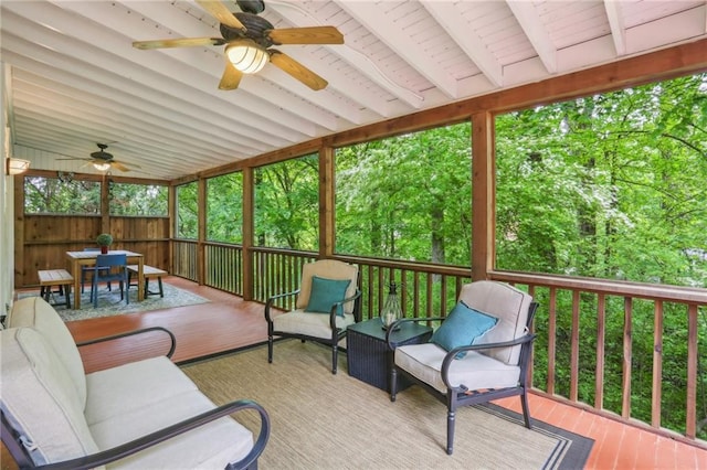 sunroom with an outdoor living space, outdoor dining space, and a ceiling fan