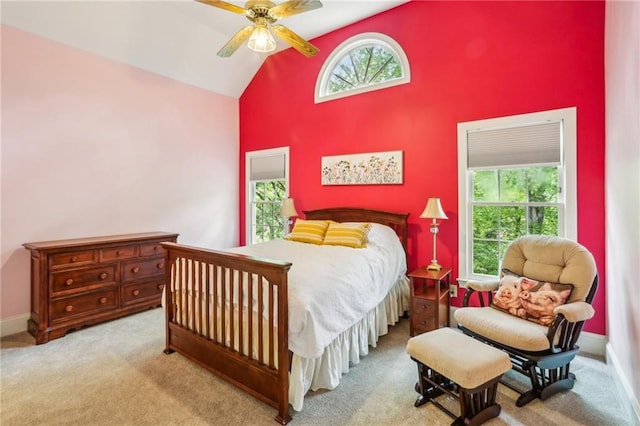 carpeted bedroom featuring ceiling fan, high vaulted ceiling, and baseboards