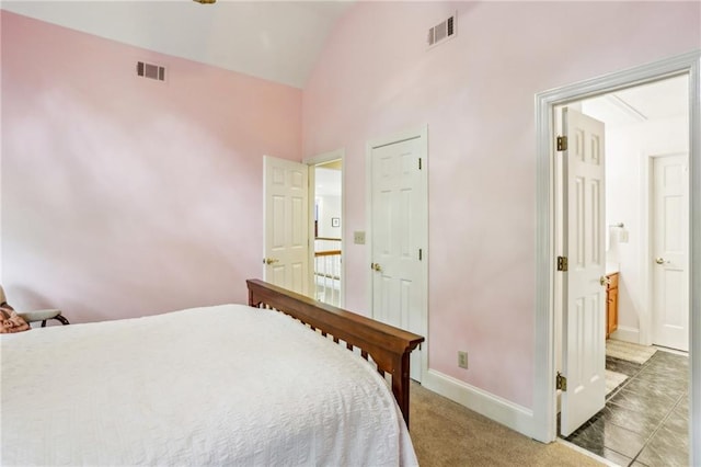 bedroom featuring light colored carpet, visible vents, lofted ceiling, and baseboards