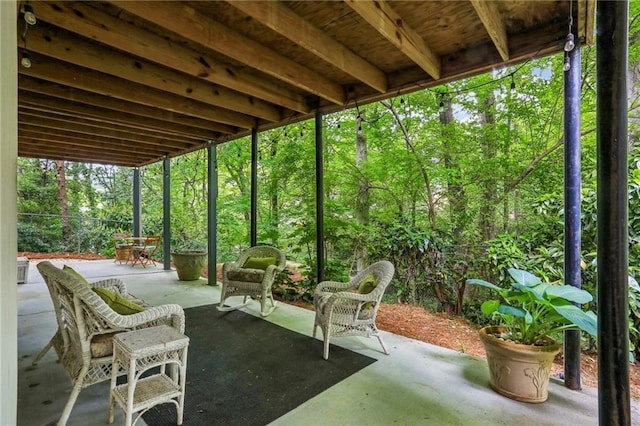 view of patio / terrace with a wooded view