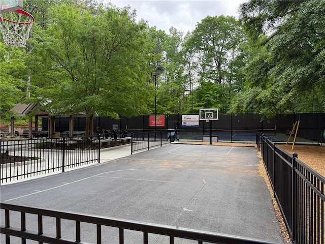 view of basketball court with fence and community basketball court