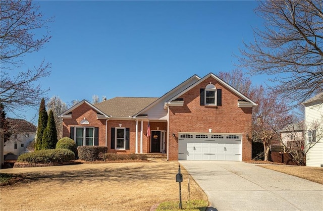 traditional home featuring concrete driveway, a garage, brick siding, and a front yard