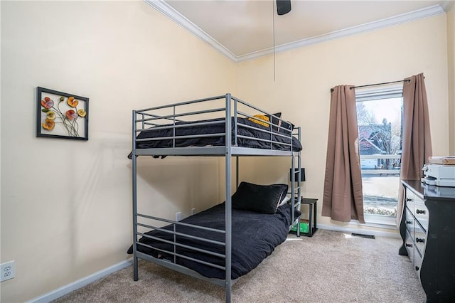 bedroom featuring a ceiling fan, crown molding, baseboards, and carpet floors