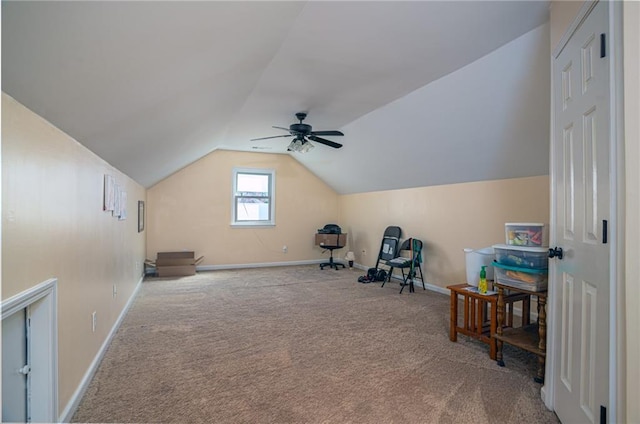 interior space with baseboards, carpet, ceiling fan, and vaulted ceiling