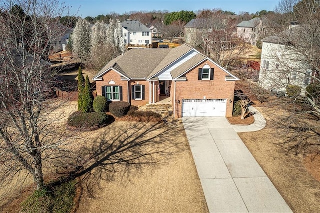 traditional home with brick siding, concrete driveway, an attached garage, and a shingled roof