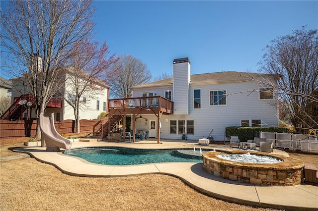 back of house featuring a patio, a fenced backyard, an outdoor fire pit, a wooden deck, and stairs