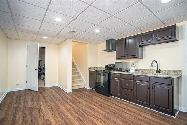 kitchen with visible vents, a sink, dark wood-style floors, black range with electric cooktop, and wall chimney exhaust hood