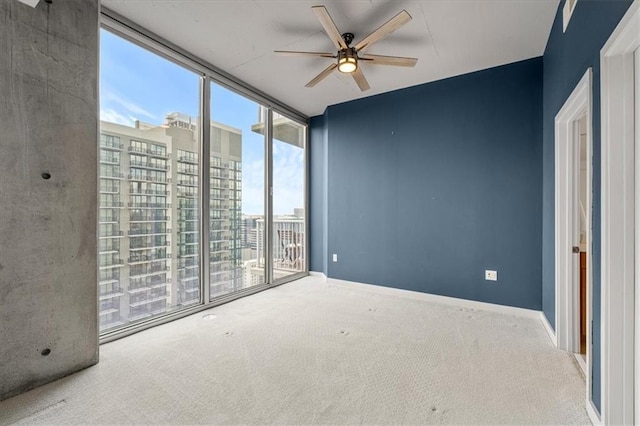 855 Peachtree St NE Unit 2713, Atlanta, GA 30308 - empty room with carpet floors, floor to ceiling windows, baseboards, and ceiling fan
