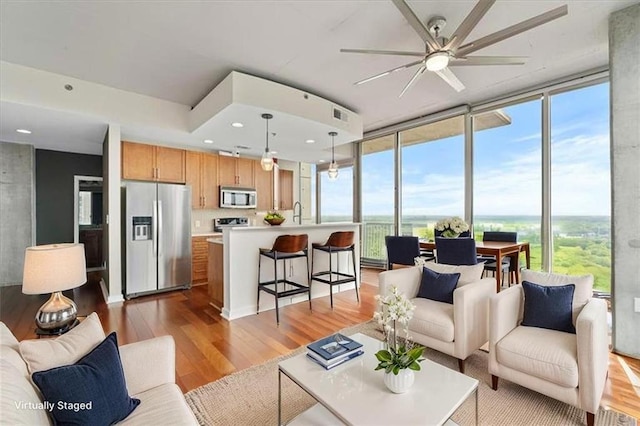 855 Peachtree St NE Unit 2713, Atlanta, GA 30308 - living room with light wood-style floors, ceiling fan, expansive windows, and visible vents