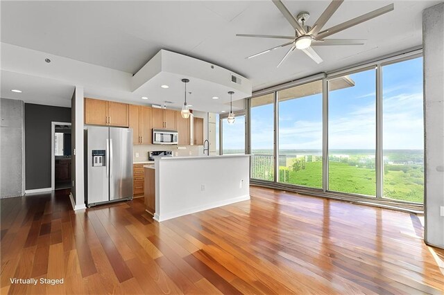 855 Peachtree St NE Unit 2713, Atlanta, GA 30308 - kitchen featuring a wall of windows, ceiling fan, dark wood-style flooring, appliances with stainless steel finishes, and light countertops