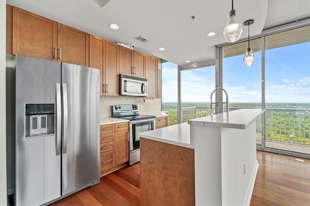 855 Peachtree St NE Unit 2713, Atlanta, GA 30308 - kitchen with light countertops, appliances with stainless steel finishes, wood finished floors, and visible vents