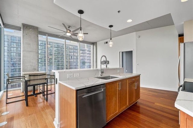 855 Peachtree St NE Unit 2713, Atlanta, GA 30308 - kitchen with brown cabinets, a sink, freestanding refrigerator, light wood-type flooring, and stainless steel dishwasher