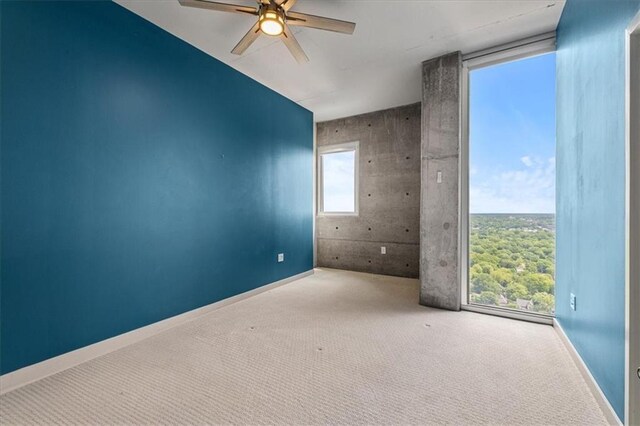 855 Peachtree St NE Unit 2713, Atlanta, GA 30308 - empty room featuring baseboards, carpet, and a ceiling fan