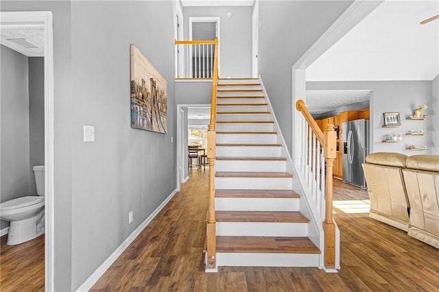 stairs featuring hardwood / wood-style floors