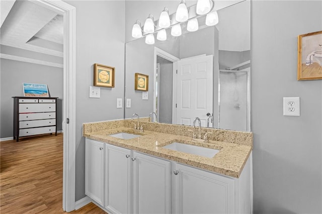 bathroom featuring vanity, a shower with shower door, and wood-type flooring