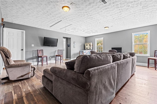 living room with hardwood / wood-style floors and a textured ceiling