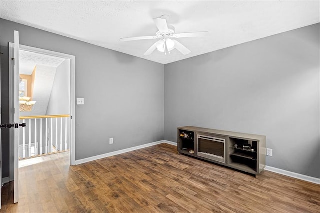 spare room featuring a textured ceiling, hardwood / wood-style flooring, and ceiling fan