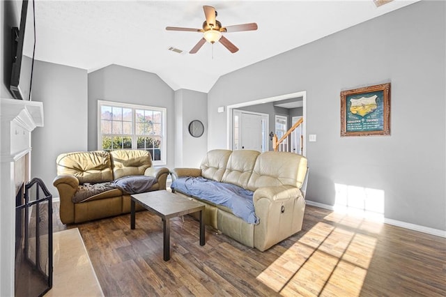 living room with vaulted ceiling, ceiling fan, and dark hardwood / wood-style floors