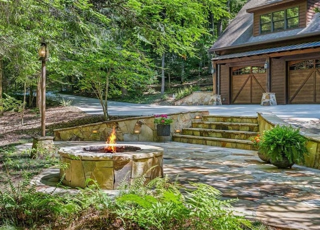 view of patio / terrace featuring an outdoor fire pit