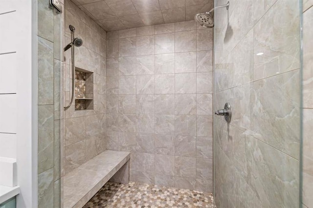 bathroom with a tile shower