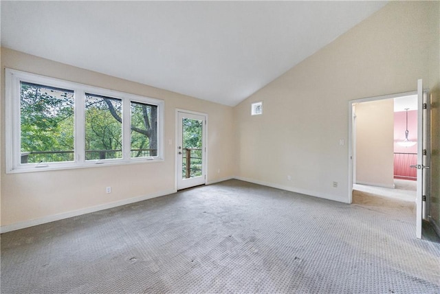 unfurnished room featuring light carpet and high vaulted ceiling